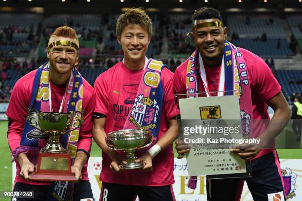 From left, Souza, Yoichiro Kakitani and Ricardo Santos of Cerezo Osaka hold Cups during the 97th All Japan Football Championship final between Cerezo...