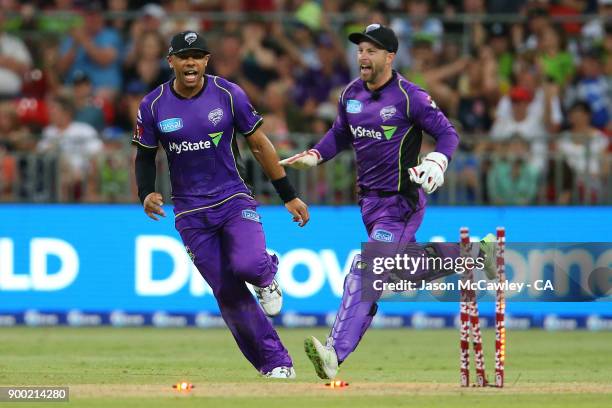 Tymal Mills of the Hurricanes and Matthew Wade celebrate the dismissal of Jos Butler of the Thunder during the Big Bash League match between the...