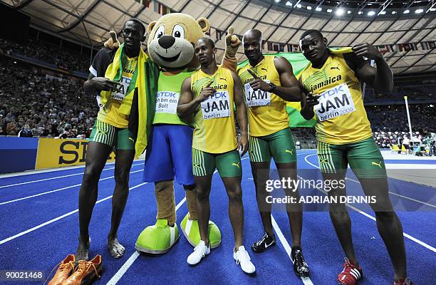 Jamaica's Usain Bolt, Michael Frater, Asafa Powell and Steve Mullings pose with mascot Berlino after winning the men's 4x100m final relay race of the...