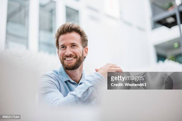 portrait of smiling businessman - selective focus stock-fotos und bilder