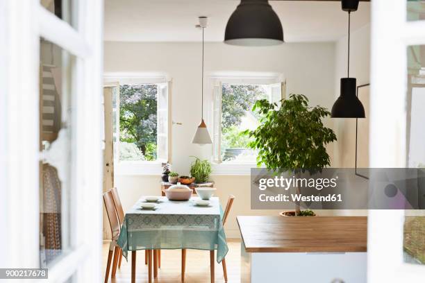 bright modern kitchen and dining room in an old country house - dining room stock-fotos und bilder