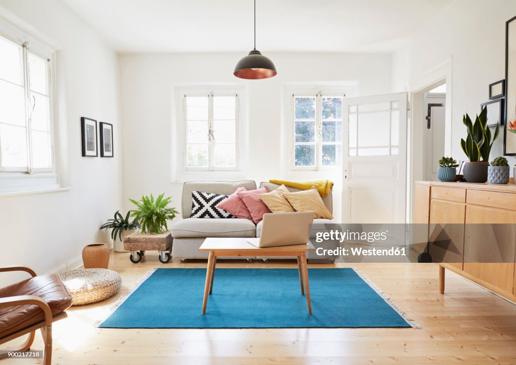 Laptop on coffee table in a modern living room of an old country house