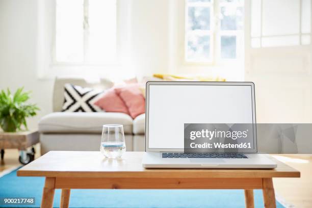 laptop on coffee table in a modern living room of an old country house - mesa baja de salón fotografías e imágenes de stock