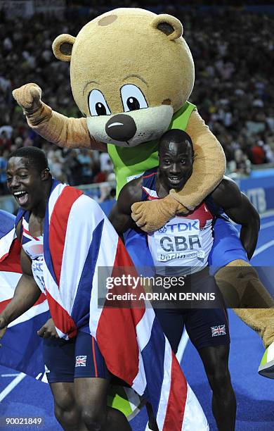 Great Britain's athlete celebrate with mascot Berlino after competing in the men's 4x100m final relay race of the 2009 IAAF Athletics World...