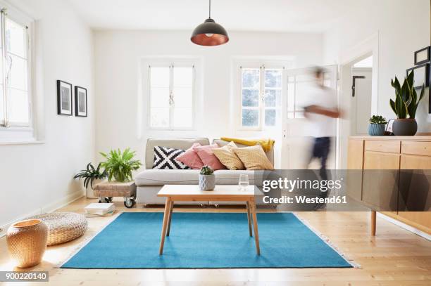 man walking in bright modern living room in an old country house - decoração de quarto rapaz imagens e fotografias de stock