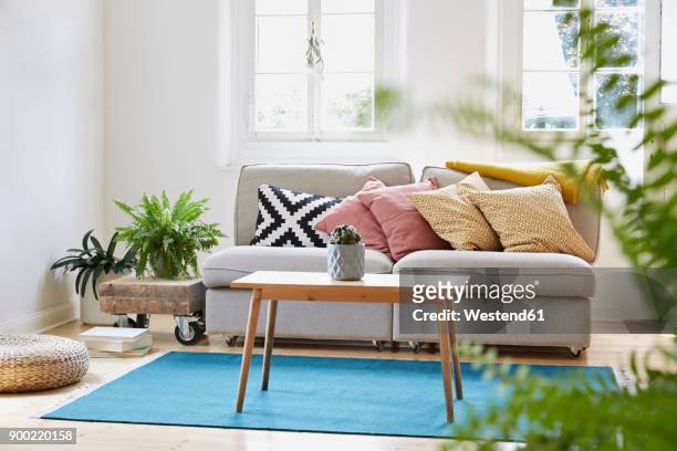 bright modern living room in an old country house - cushion stock pictures, royalty-free photos & images