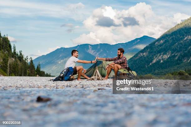 germany, bavaria, two hikers camping on gravel bank - zelt stock-fotos und bilder