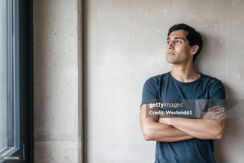 Young man looking out of window