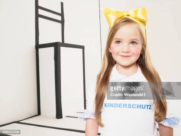 portrait of smiling little girl dressed up as alice in wonderland - alice franco foto e immagini stock