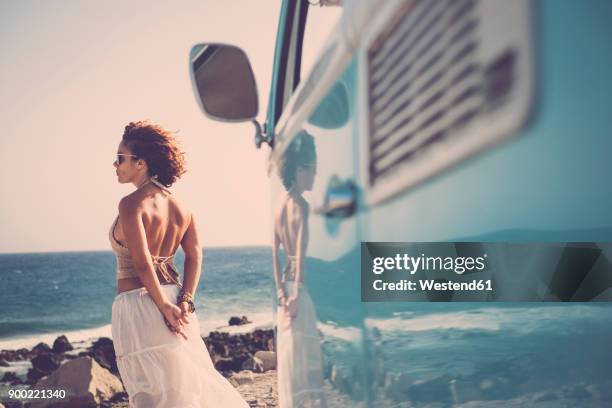 spain, tenerife, smiling woman standing at seaside looking at distance - ankle length stock pictures, royalty-free photos & images