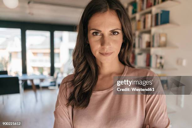 portrait of confident woman at home - mujeres de mediana edad fotografías e imágenes de stock