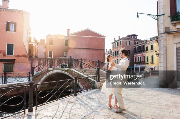 italy, venice, dancing bridal couple at sunrise - venetian bildbanksfoton och bilder