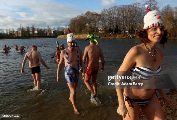 Winter swimmers bathe in Orankesee lake on January 1, 2018 in Berlin, Germany. Unseasonably higher-than-average winter temperatures meant no ice for...