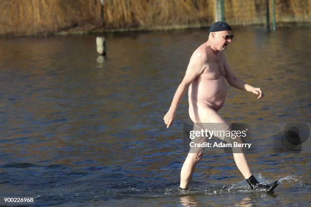 Winter swimmer bathes in Orankesee lake on January 1, 2018 in Berlin, Germany. Unseasonably higher-than-average winter temperatures meant no ice for...