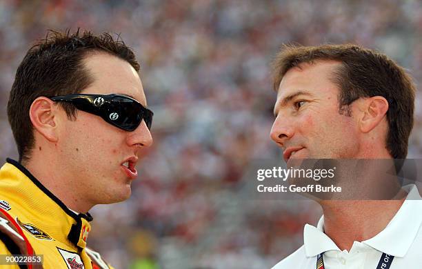 Kyle Busch , driver of the M&M's Toyota, talks with team owner J.D. Gibbs prior to the NASCAR Sprint Cup Series Sharpie 500 at Bristol Motor Speedway...