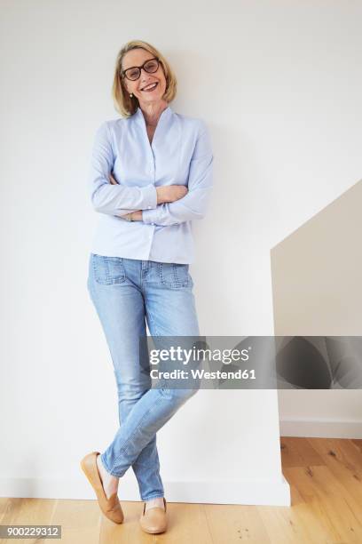 portrait of happy mature woman at home - man portrait full body 50's stock-fotos und bilder