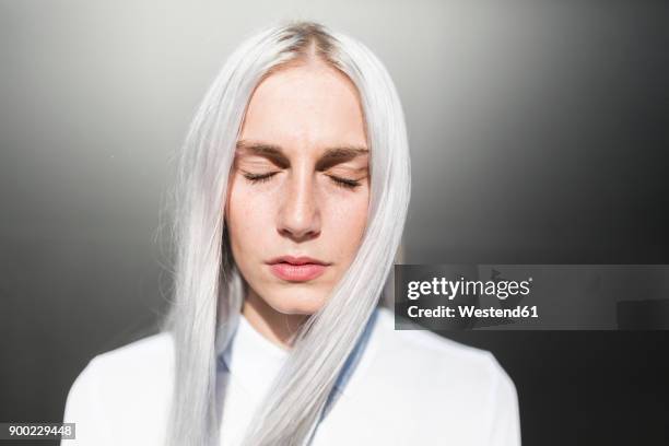 portrait of serious young woman with closed eyes - young woman grey hair stock pictures, royalty-free photos & images