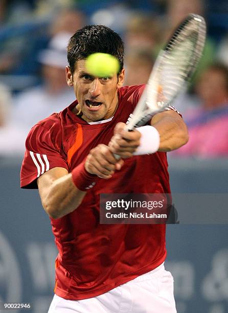 Novak Djokovic of Serbia hits a backhand against Rafael Nadal of Spain in their semi final during day six of the Western & Southern Financial Group...