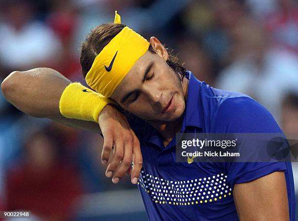 Rafael Nadal of Spain wipes sweat from his face against Novak Djokovic of Serbia during day six of the Western & Southern Financial Group Masters on...