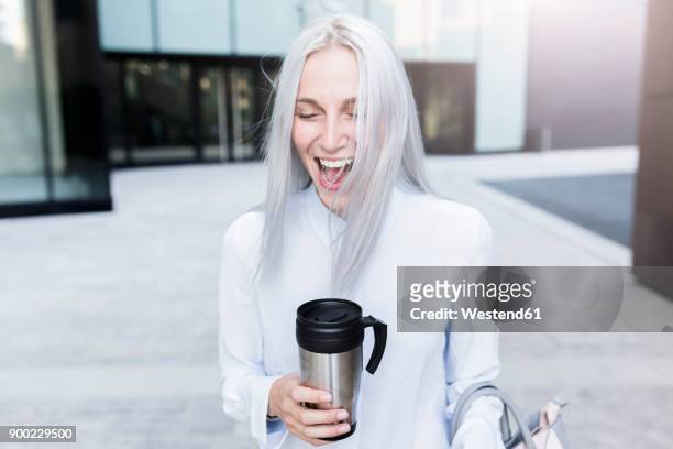 screaming young businesswoman holding coffee mug in the city - young woman grey hair stock pictures, royalty-free photos & images