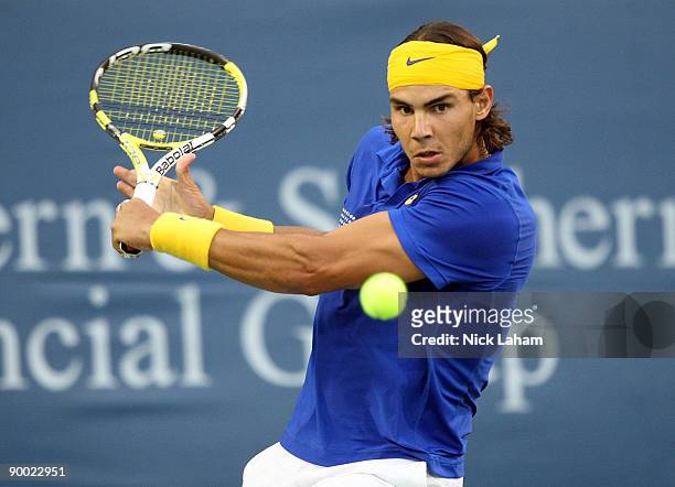 Rafael Nadal of Spain hits a backhand against Novak Djokovic of Serbia in their semi final during day six of the Western & Southern Financial Group...