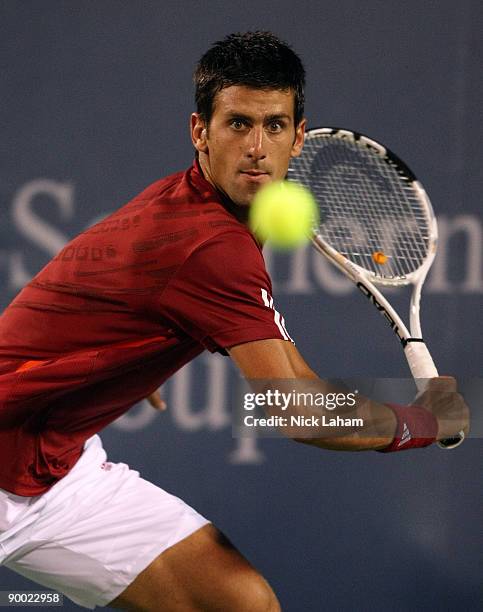 Novak Djokovic of Serbia hits a backhand against Rafael Nadal of Spain in their semi final during day six of the Western & Southern Financial Group...
