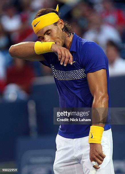 Rafael Nadal of Spain wipes sweat from his face against Novak Djokovic of Serbia during day six of the Western & Southern Financial Group Masters on...