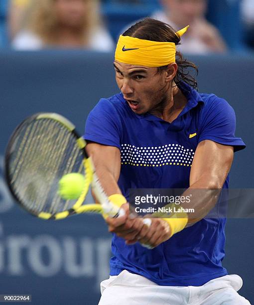 Rafael Nadal of Spain hits a backhand against Novak Djokovic of Serbia in their semi final during day six of the Western & Southern Financial Group...