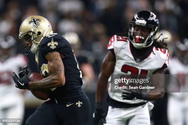 Ted Ginn of the New Orleans Saints scores a touchdown against Desmond Trufant of the Atlanta Falcons during the first half of a game at the...
