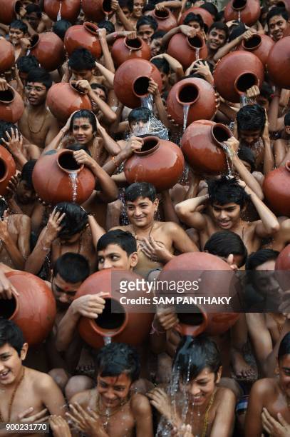 Indian Hindu students from the Swaminarayan Gurukul participate in the 'Magh Snan' or holy bath in Ahmedabad on January 1, 2018. Students of...