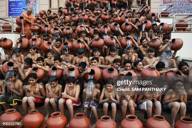 Indian Hindu students from the Swaminarayan Gurukul participate in a 'Magh Snan' or holy bath in Ahmedabad on January 1, 2018. Students of...