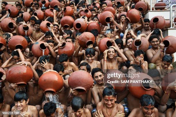 Indian Hindu students from the Swaminarayan Gurukul participate in the 'Magh Snan' or holy bath in Ahmedabad on January 1, 2018. Students of...