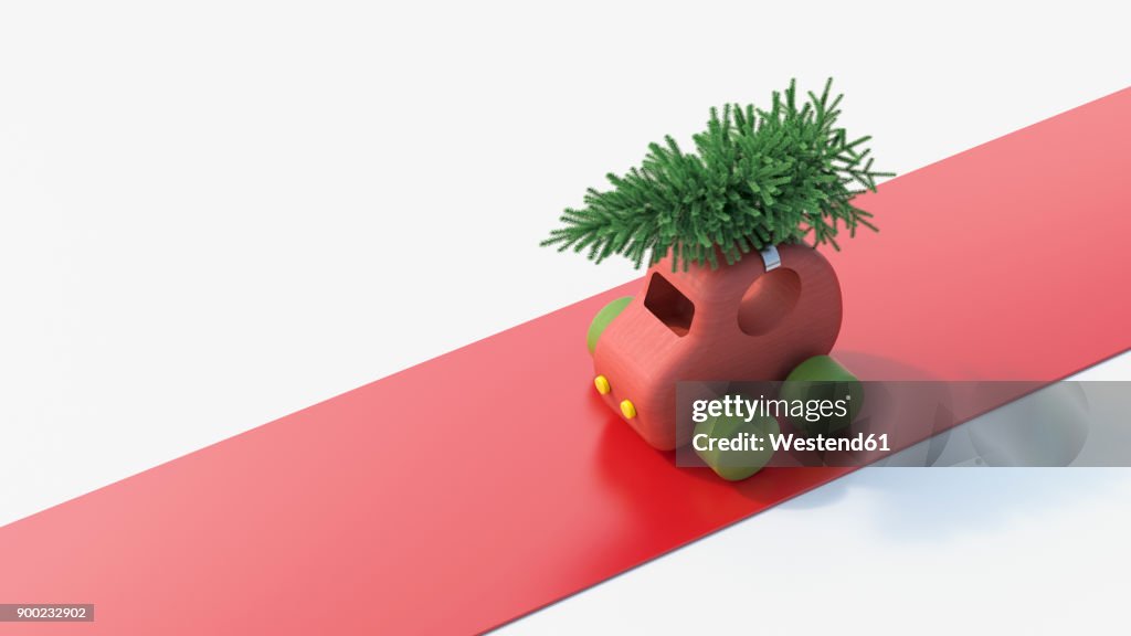 Toy car carrying Christmas tree on the roof