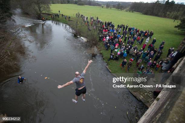 Man takes part in the Mappleton Bridge Jump, an annual unofficial tradition where those willing jump from Okeover bridge on New Years Day into the...