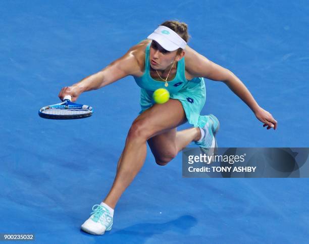Elise Mertens of Belgium hits a return against Angelique Kerber of Germany during their fourth session women's singles match on day three of the...