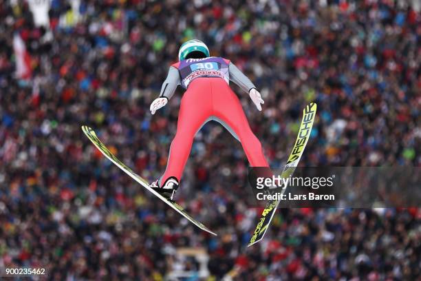 Michael Hayboeck of Austria competes at the first round on day 4 of the FIS Nordic World Cup Four Hills Tournament ski jumping event at...