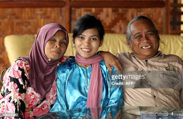 Malaysia-Islam-religion-crime-Singapore BY M. JEGATHESAN Muslim model Kartika Sari Dewi Shukarno poses with her mother Badariah Meor Abdul Salim and...
