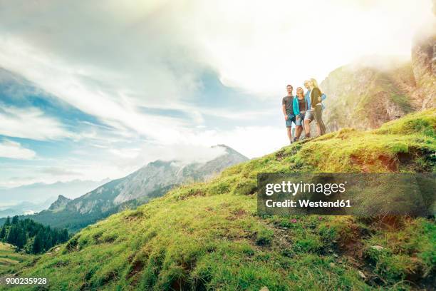 germany, bavaria, pfronten, family enjoying the view on alpine meadow near aggenstein - tourism life in bavaria foto e immagini stock