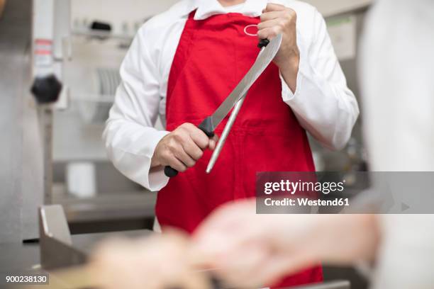 butcher sharpening his knife - butcher knife stock pictures, royalty-free photos & images