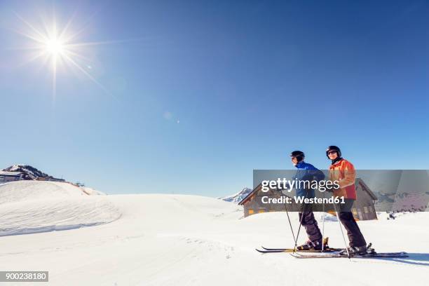 austria, damuels, couple with skiers in winter landscape - vorarlberg stockfoto's en -beelden