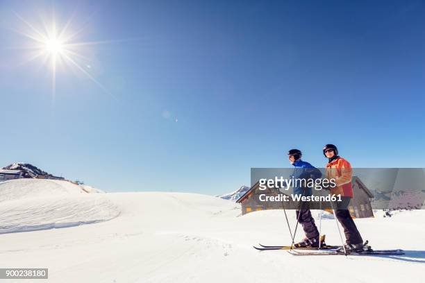 austria, damuels, couple with skiers in winter landscape - vorarlberg imagens e fotografias de stock
