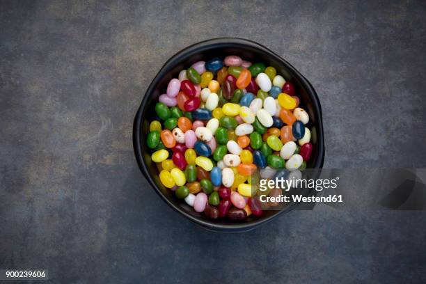 bowl of colourful sweet jellybeans on grey background - jellybean stock pictures, royalty-free photos & images