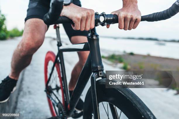 close-up of young man on fixie bike - handlebar stock pictures, royalty-free photos & images