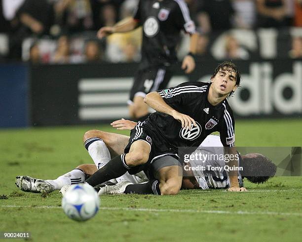 Dejan Jakovic of D.C. United crashes to the ground after tackling Alan Gordon of the Los Angeles Galaxy during an MLS match at RFK Stadium on August...