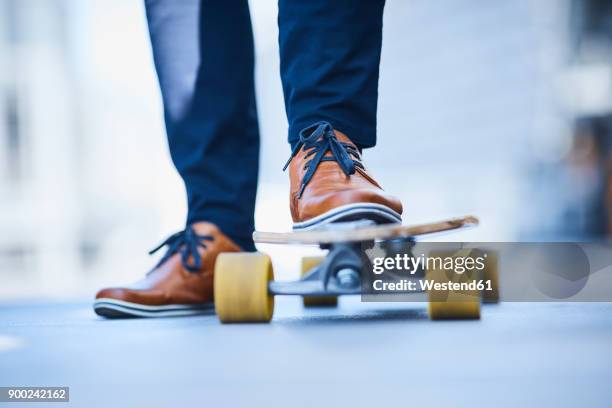 close-up of man riding longboard - smart shoes stock pictures, royalty-free photos & images