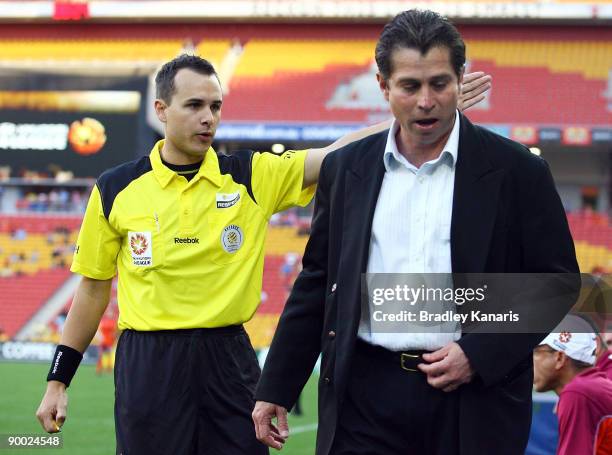 Roar coach Frank Farina is sent from the field by a sideline official during the round three A-League match between the Brisbane Roar and the...