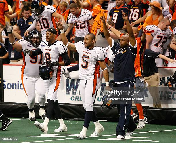 Members of the Spokane Shock including Markee White and Charles Dillon walk on the field to celebrate as time expires in the team's 74-27 victory...