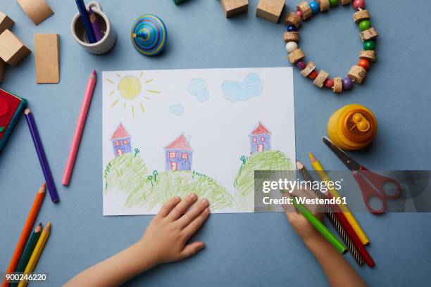 child drawing landscape with houses - kid hand raised stock pictures, royalty-free photos & images