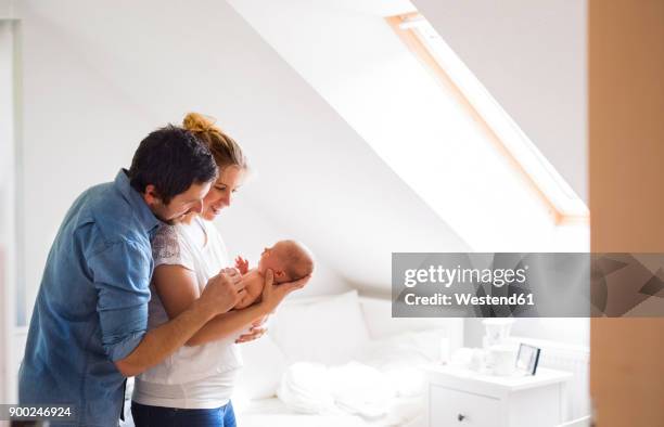 parents cuddling with little baby at home - new life stock pictures, royalty-free photos & images