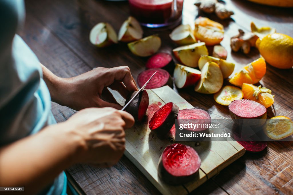 Woman's hands chopping beetroot for squeezing juice